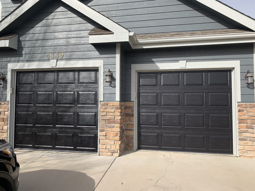 Black traditional garage with a white boarder.