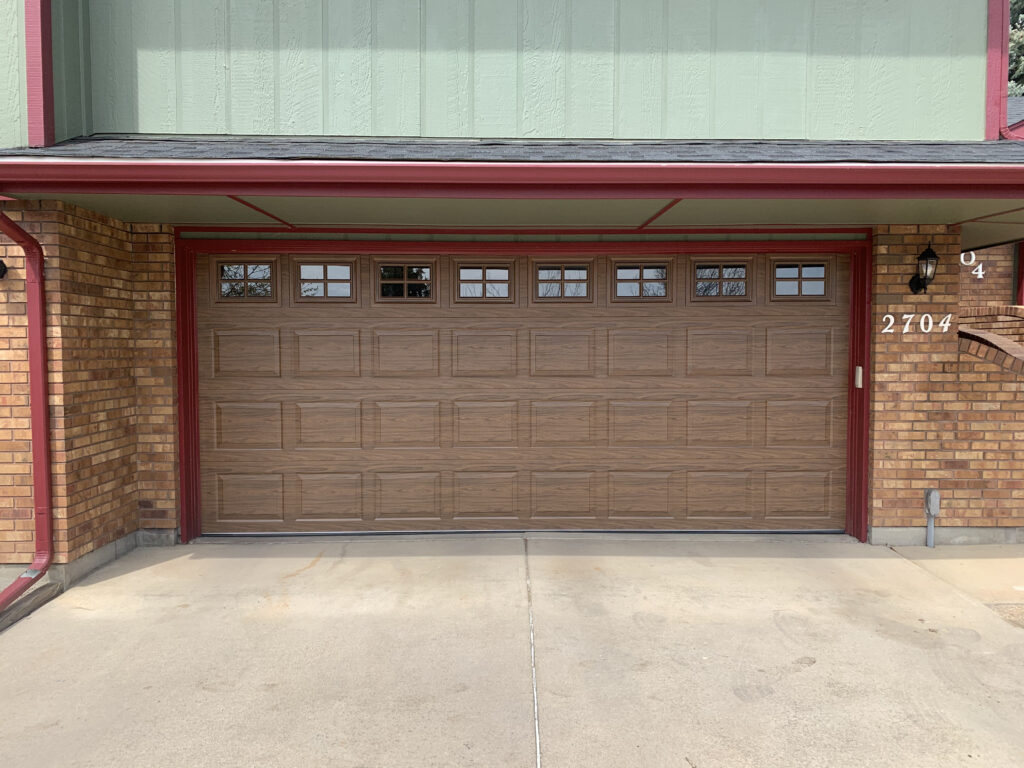 Faux wood tradtitional garage door with windows.