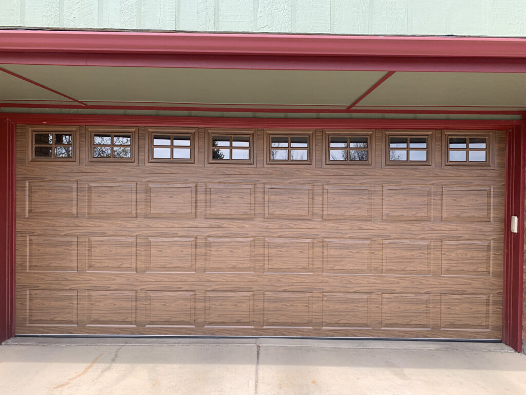 Faux wood tradtitional garage door with windows.